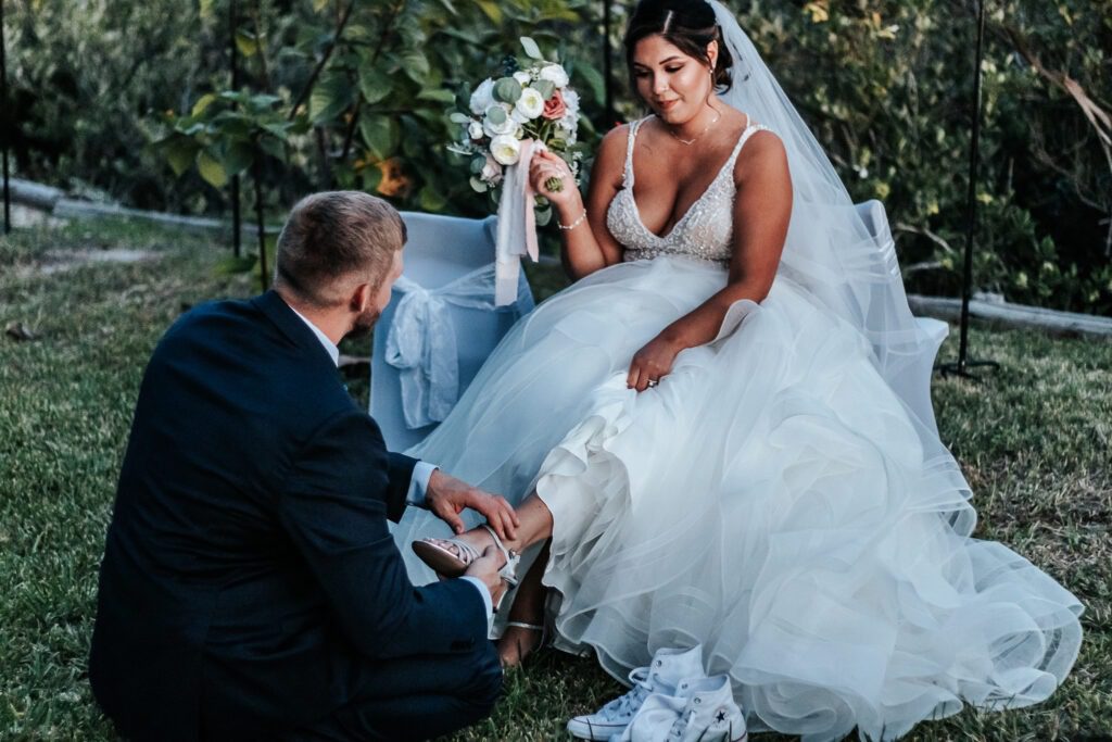 a woman in a wedding dress kneeling down