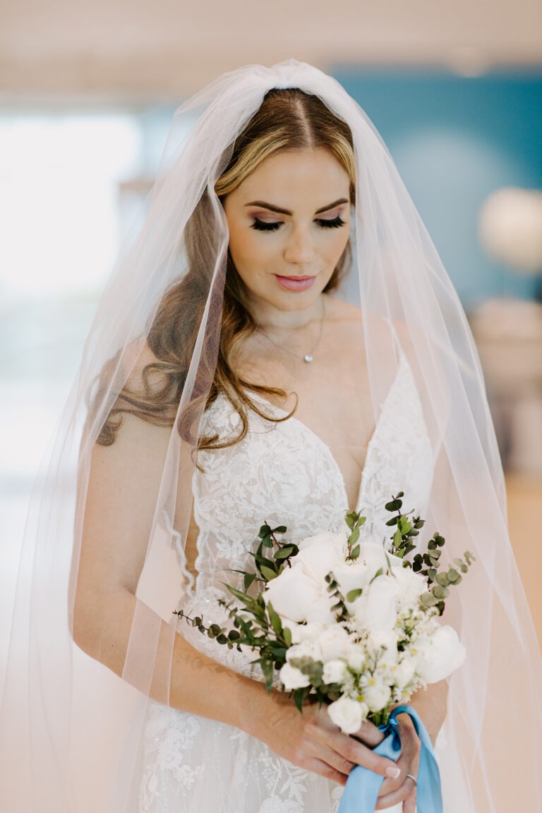 a woman in a wedding dress holding a bouquet